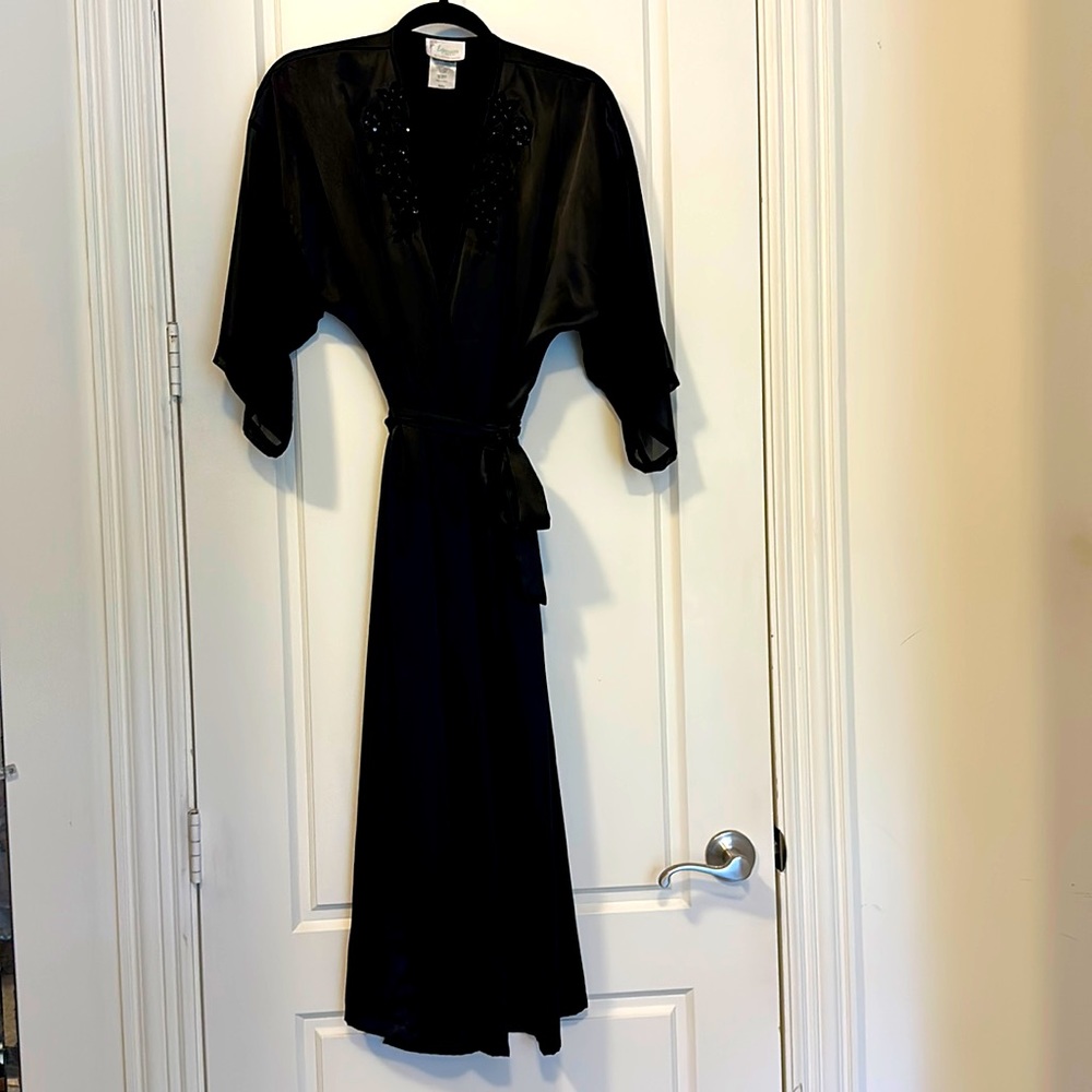 Satin-like feel for a long 100% polyester robe. Sheer 3/4 length sleeves.